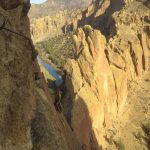 Peter Keene (instructor) follows a traverse pitch on Sky Ridge (5.8 R) with the Monkey Face visible in the background.