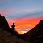 Morning glow sillouetting John Mackinnon on the way up to Rainbow Buttress in Oak Creek Canyon